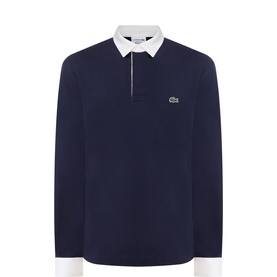 Lacoste long-sleeve rugby polo in dark navy blue with white contrast collar, cuffs, and zip placket, embroidered crocodile logo on chest