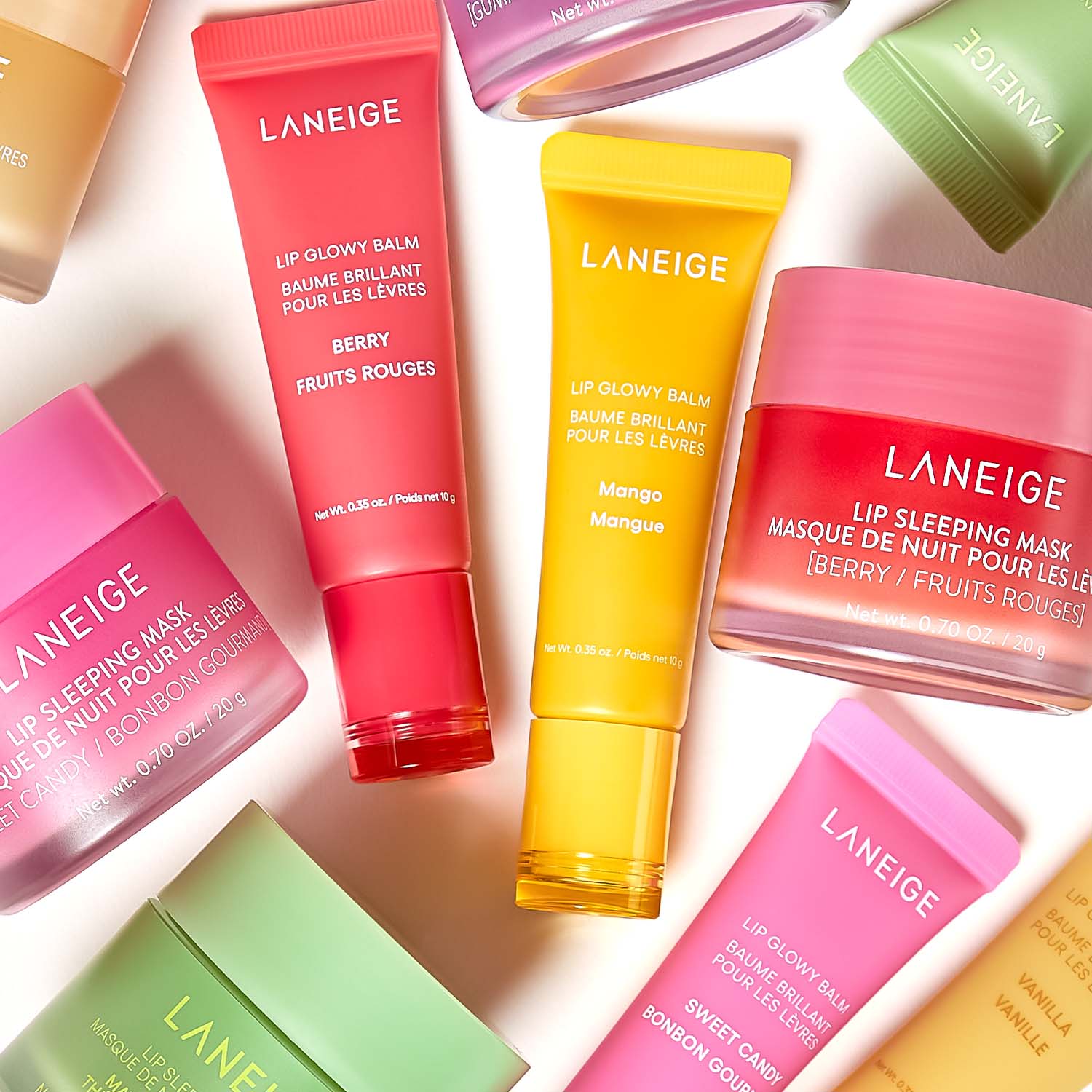 Assorted Laneige lip care products, including tubes and jars, in various colors and flavors like berry and mango.