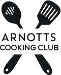 Four kitchen utensils form an X shape above the text 'ARNOTTS COOKING CLUB'.