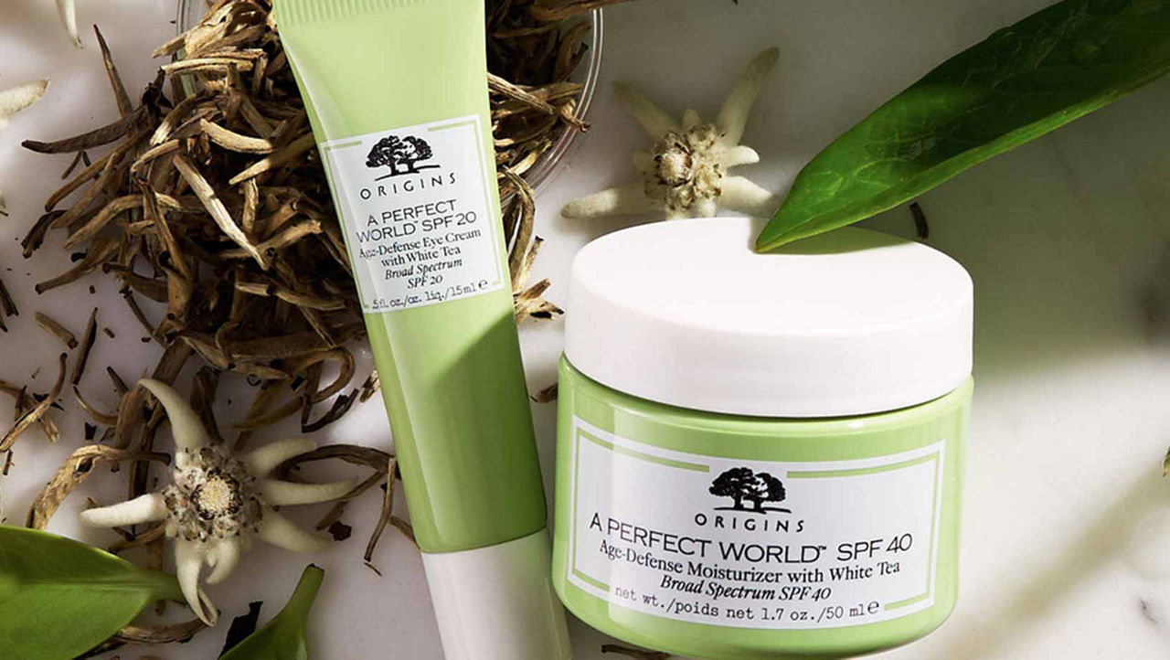 Origins oil-free SPF 40 moisturizer and Eye Cream on a marbel counter with dried white tea and green leafs in the background