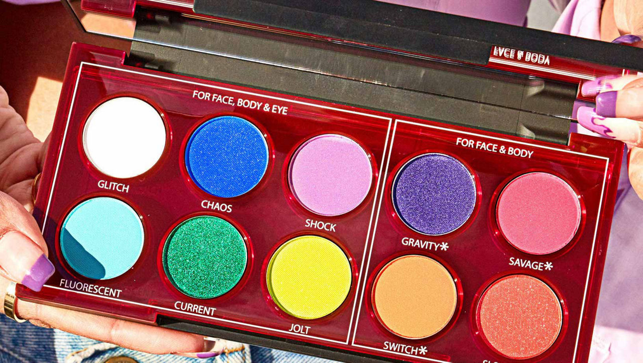 Urban Decay Wired Pressed Pigment Palette held open by a woman with purple nails