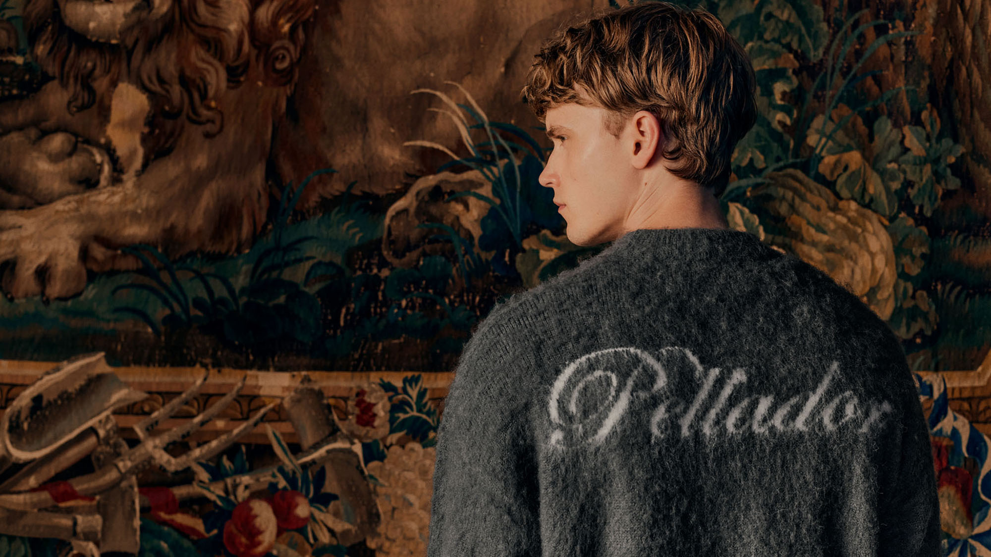 Menswear model wearing Pellador textured knit jumper with script logo on the back