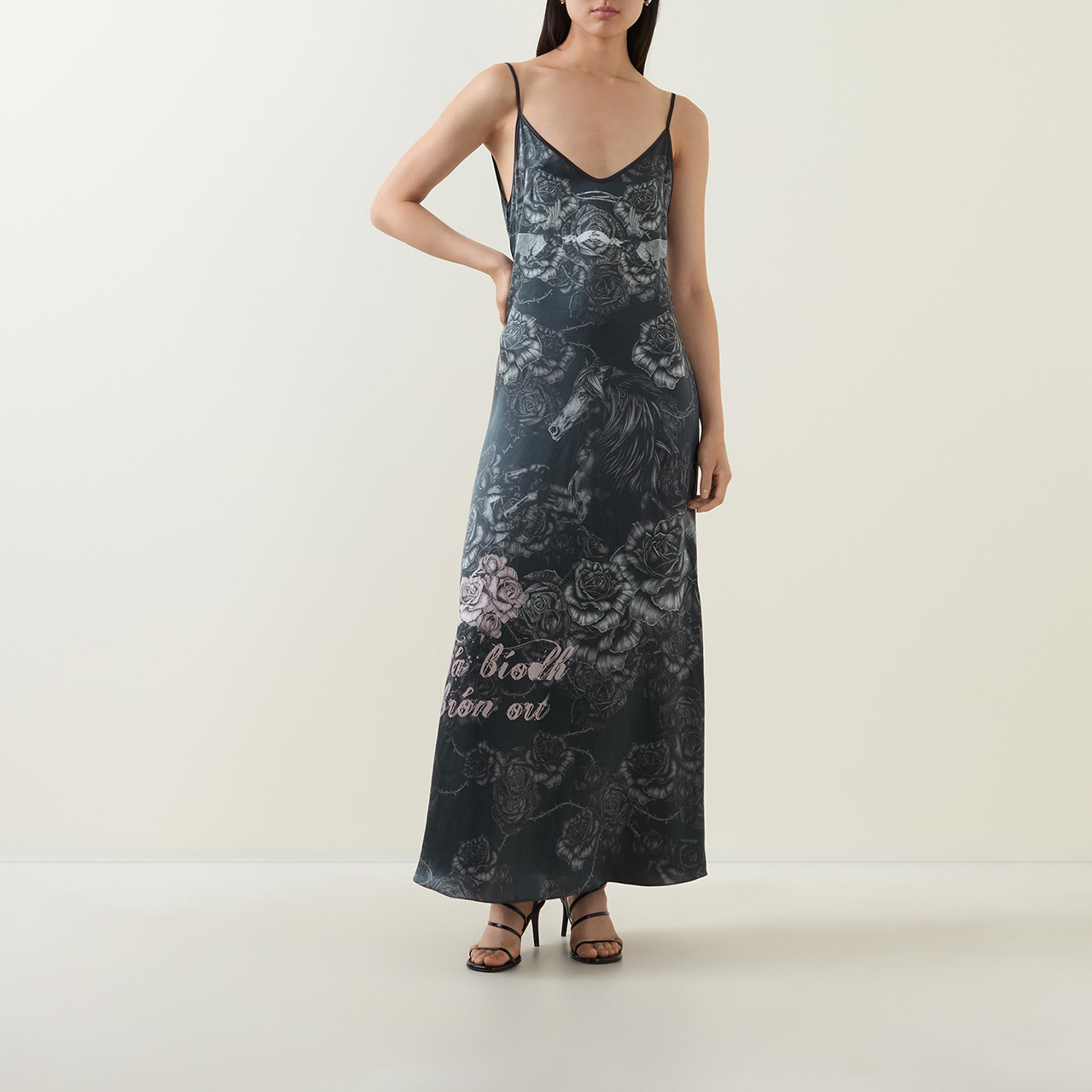 Model wearing long strappy Sara O'Neill graphic print dress