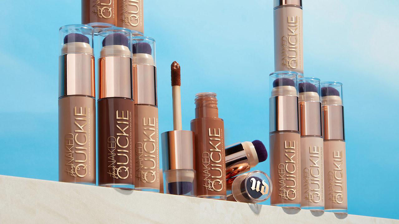 
Several makeup foundation bottles with a blue background, some open with applicators visible.

