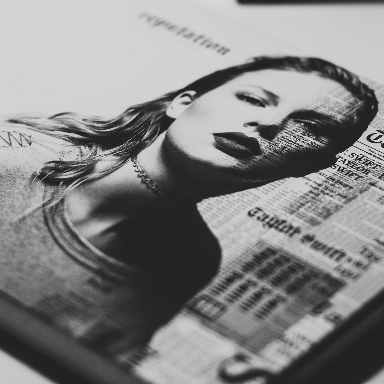 Black and white photo of a woman with newspaper text overlay on her face..
