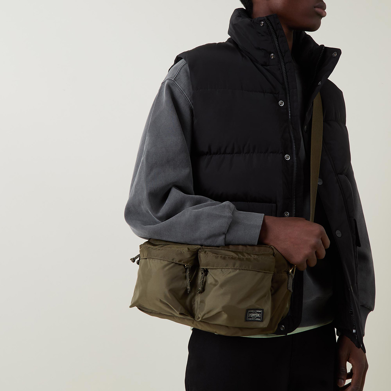 Accessories Menswear model carrying Porter shoulder bag