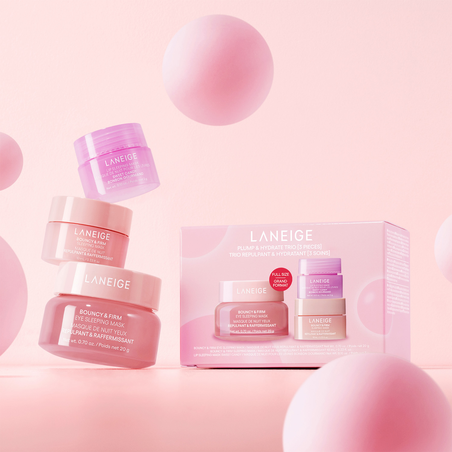 Laneige skincare products, including jars and a box set, with pink spherical elements on a pastel pink background.