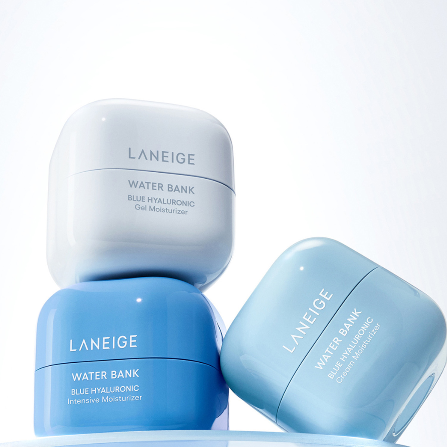 Three Laneige Water Bank moisturizers in different shades of blue are stacked against a light background.