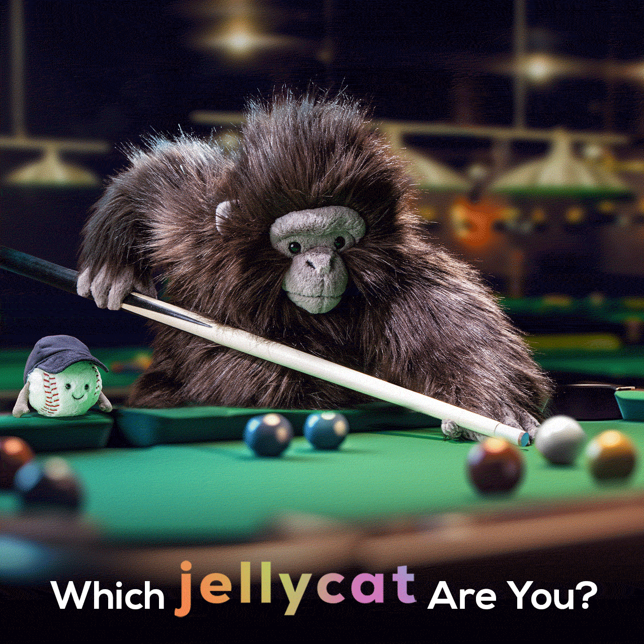 A plush gorilla plays pool with a plush baseball character. Text reads 'Which Jellycat Are You?'